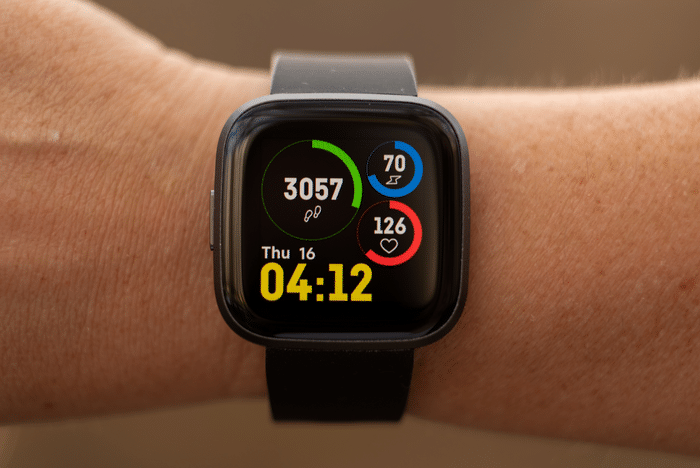 Smartwatch displaying step count on a wrist during an outdoor walk