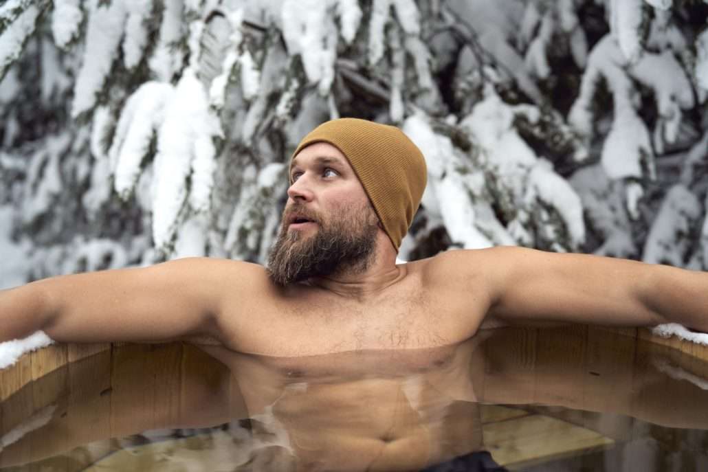 Athlete sitting in a cold water immersion tub after training