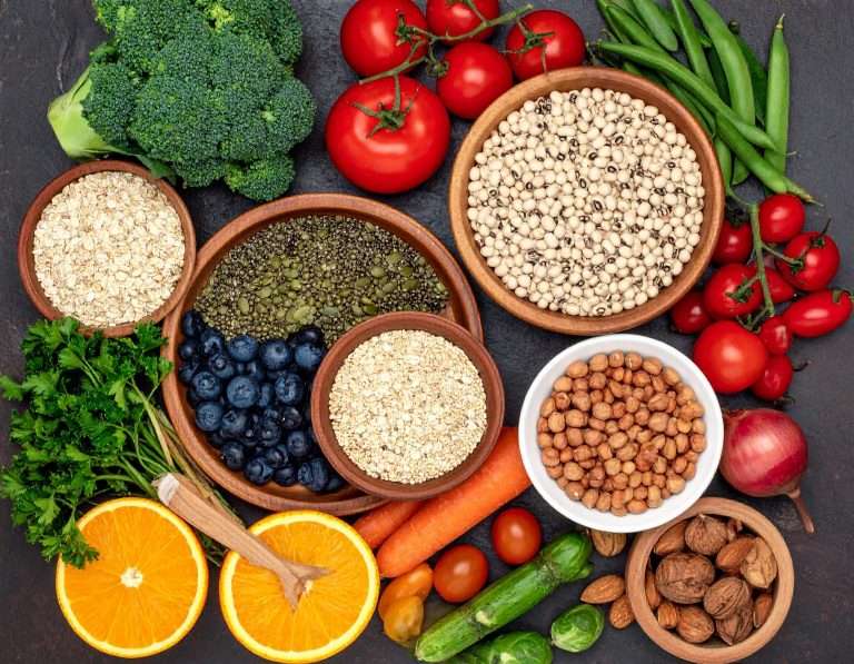 A spread of high fiber foods including vegetables, legumes and whole grains