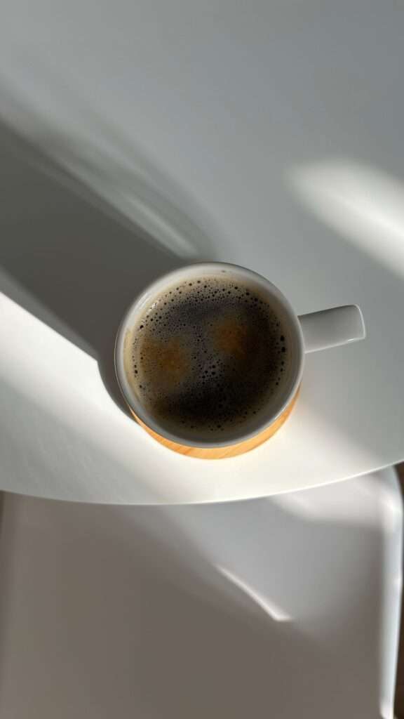 A daily cup of coffee on a table, part of a healthy coffee routine