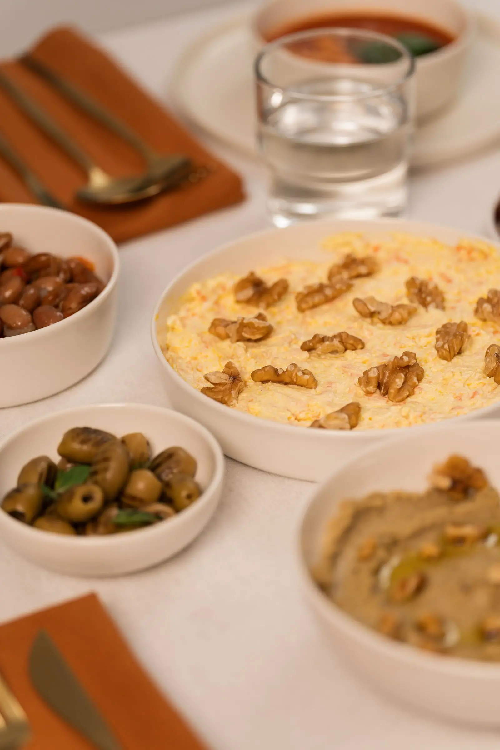 Mediterranean diet spread with olives, hummus, beans, and walnuts, heart-healthy foods