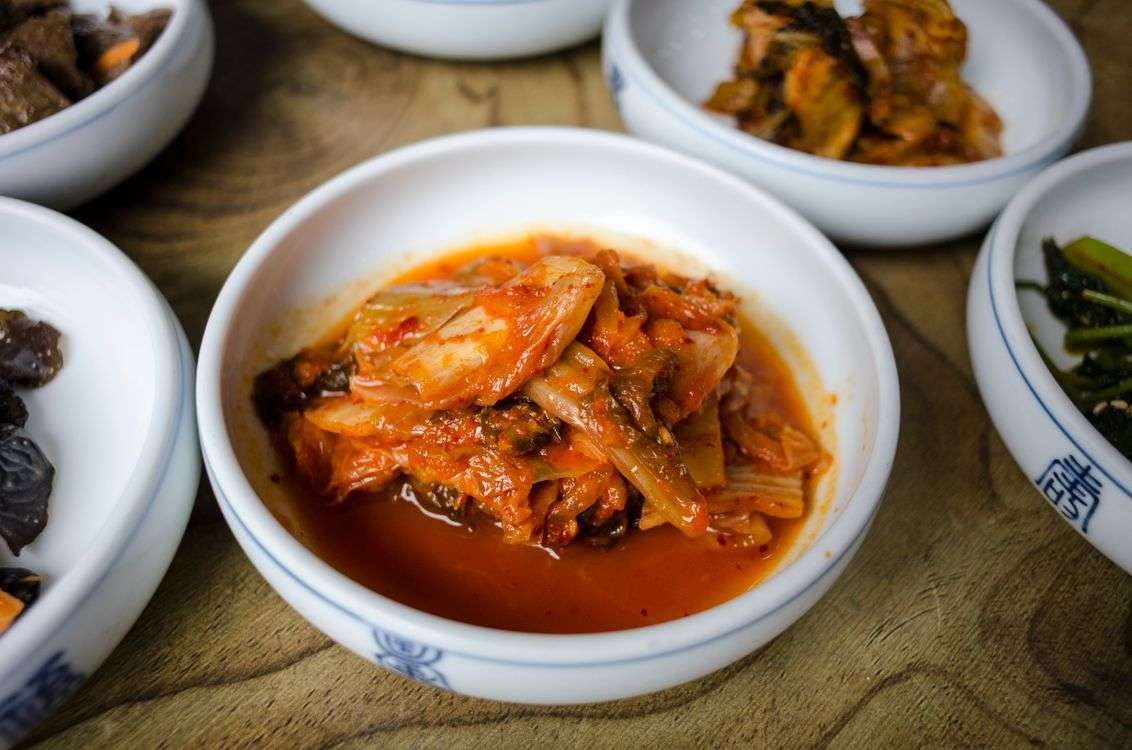 Bowl of kimchi, a fermented food that supports gut health and helps ease signs of an unhealthy gut