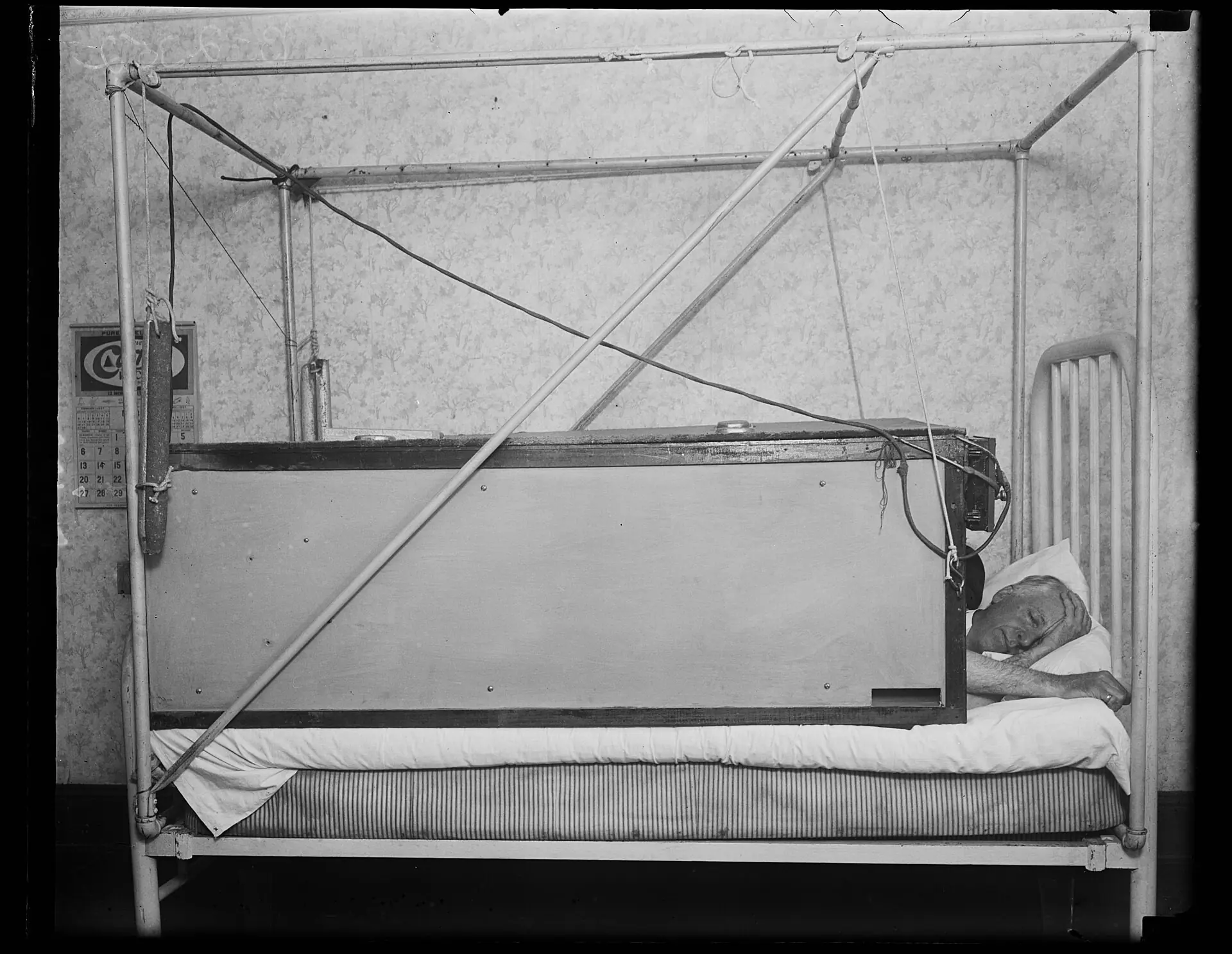 Archival photograph of a man sleeping in bed