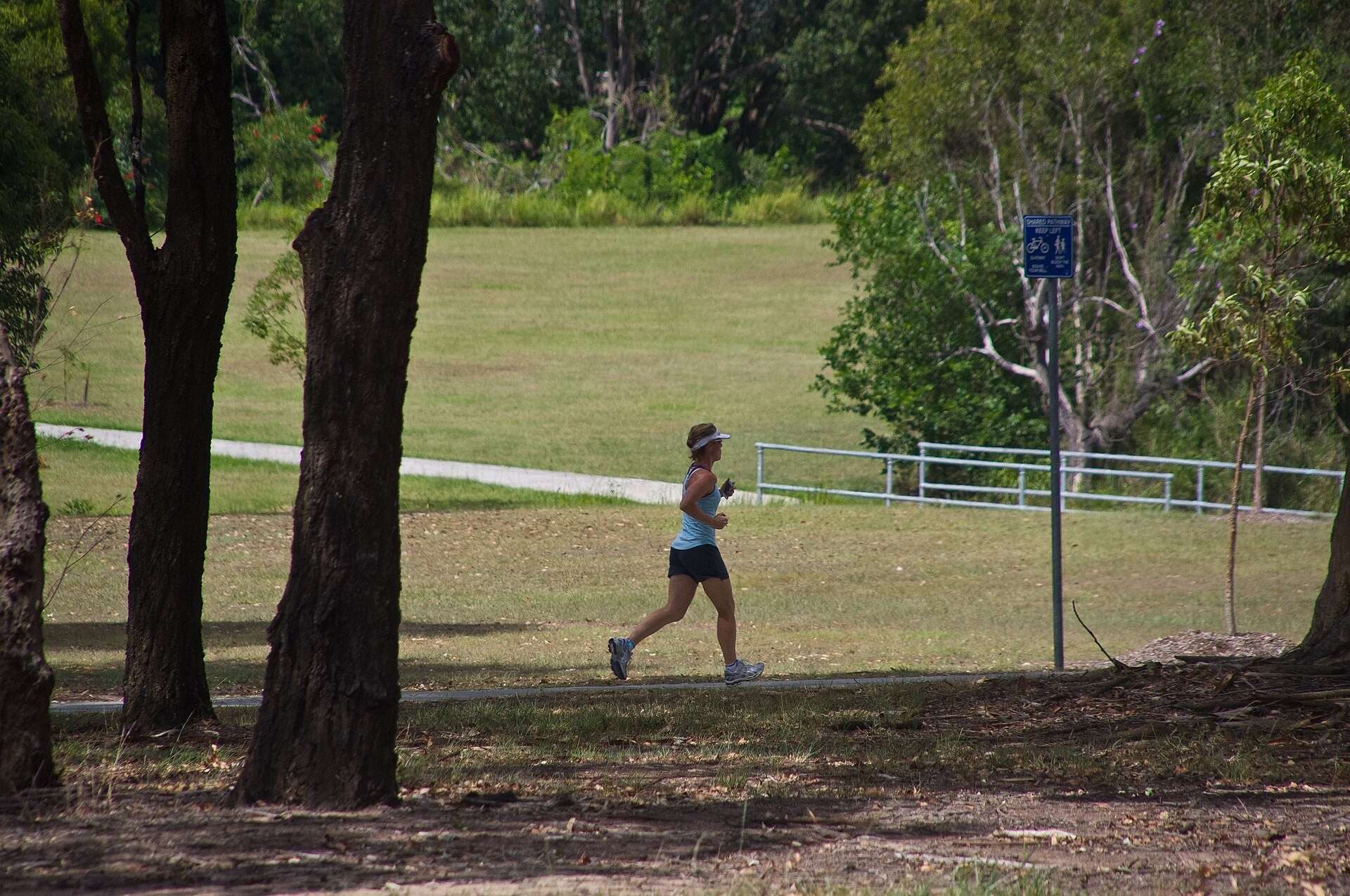Woman jogging on a path through a park